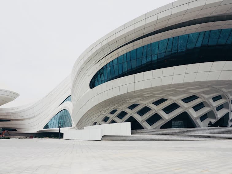 Modern architectural design featuring futuristic curves and glass facades